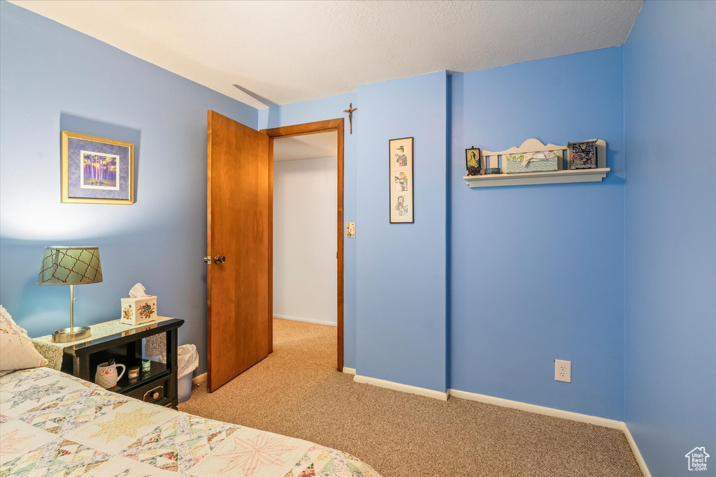 Carpeted bedroom with baseboards