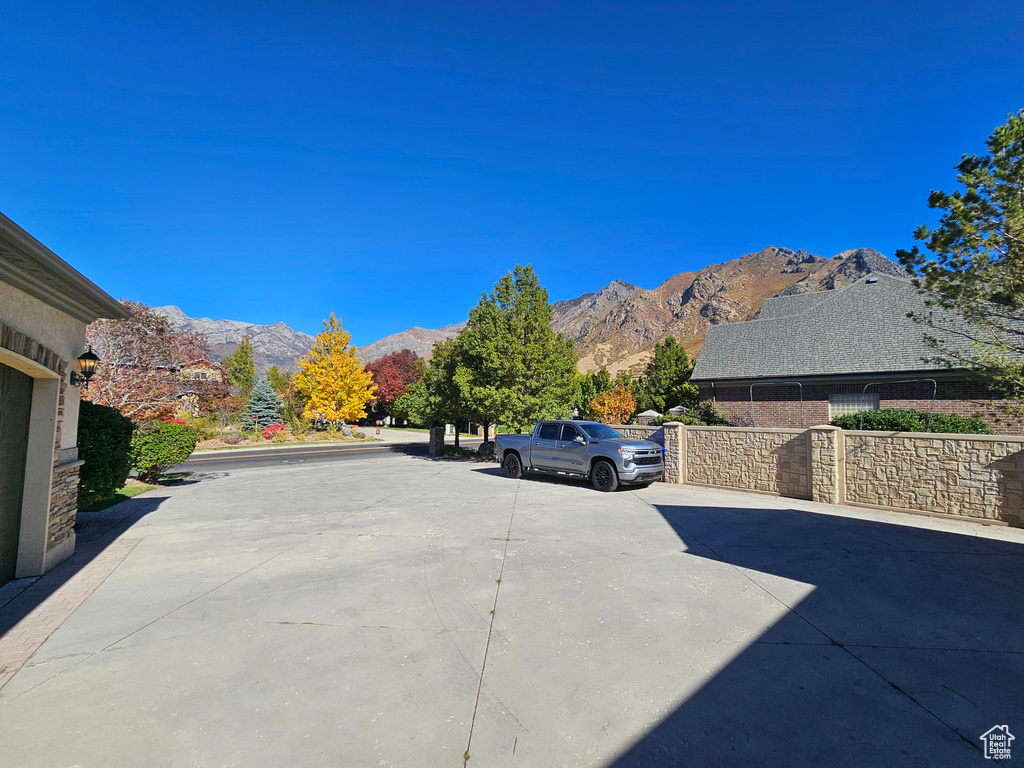 View of road featuring a mountain view and concrete driveway