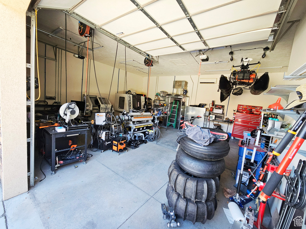 Garage featuring a workshop area and a garage door opener