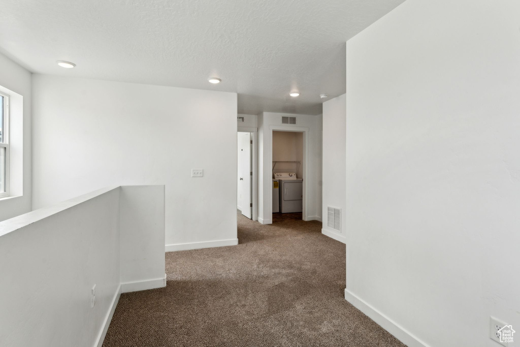 Corridor featuring carpet floors, baseboards, an upstairs landing, and visible vents
