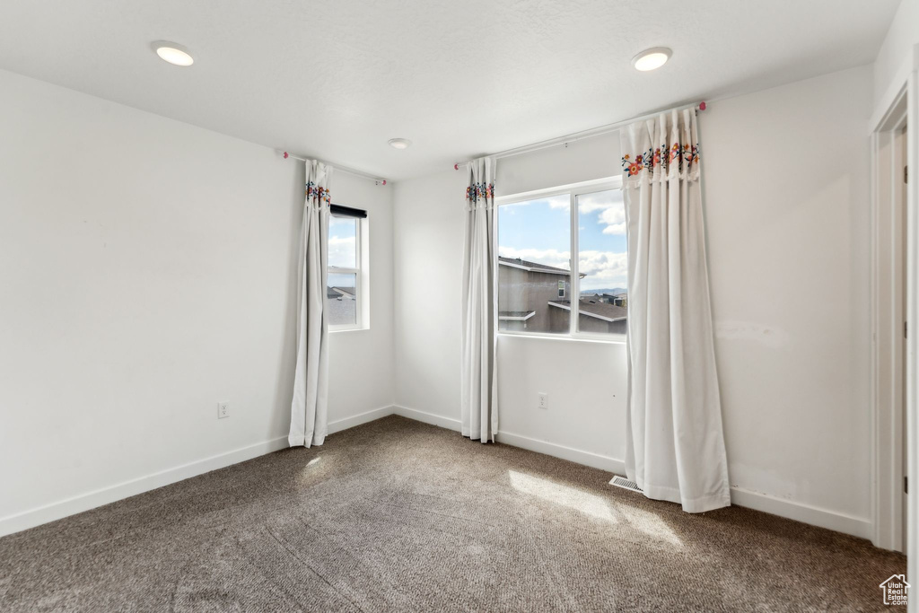 Unfurnished room with baseboards, carpet, and recessed lighting
