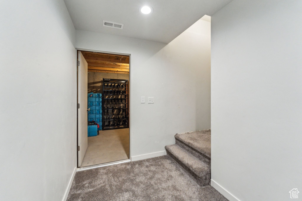 Corridor featuring carpet flooring, recessed lighting, baseboards, visible vents, and stairway