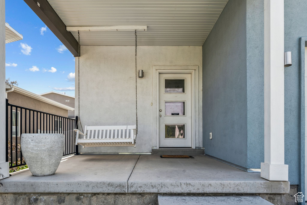 View of exterior entry with stucco siding