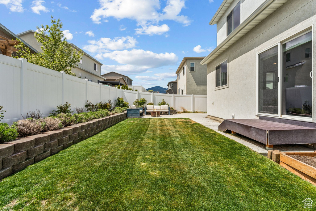 View of yard featuring a deck, a residential view, a patio area, an outdoor hangout area, and a fenced backyard