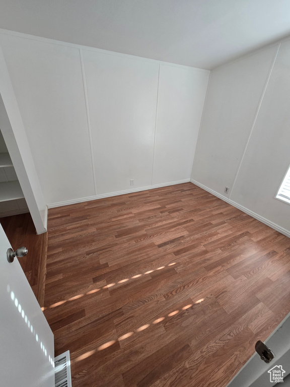 Unfurnished room with visible vents and wood finished floors