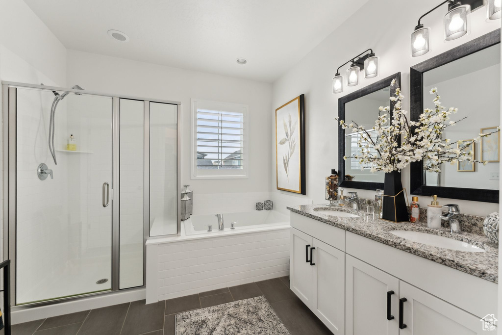 Full bathroom with a sink, a bath, and a shower stall