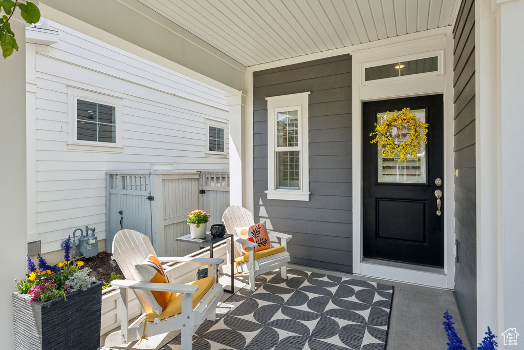 Property entrance with fence and covered porch