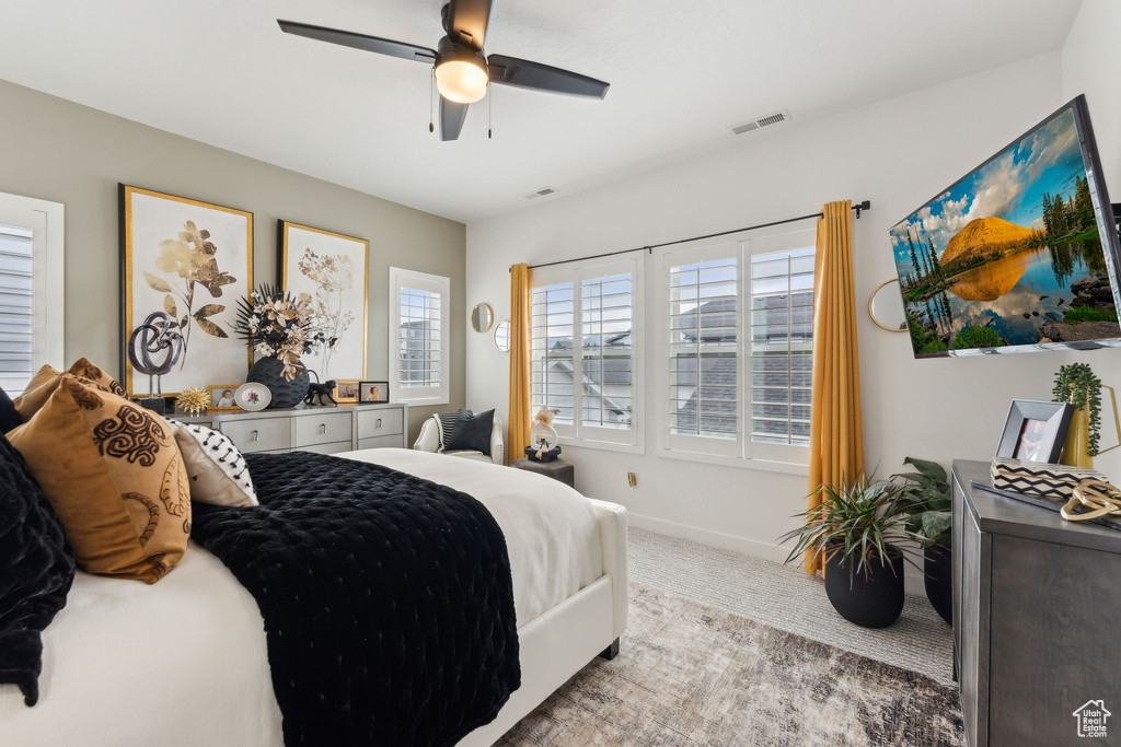 Bedroom featuring baseboards, ceiling fan, carpet, and visible vents
