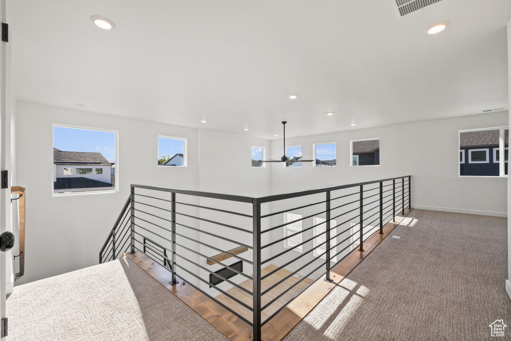Hallway featuring baseboards, recessed lighting, and visible vents