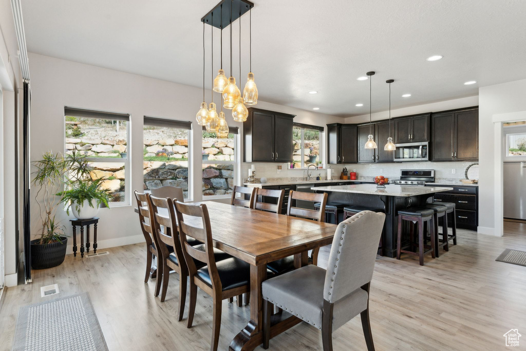 Dining space with recessed lighting, light wood-style flooring, baseboards, and visible vents