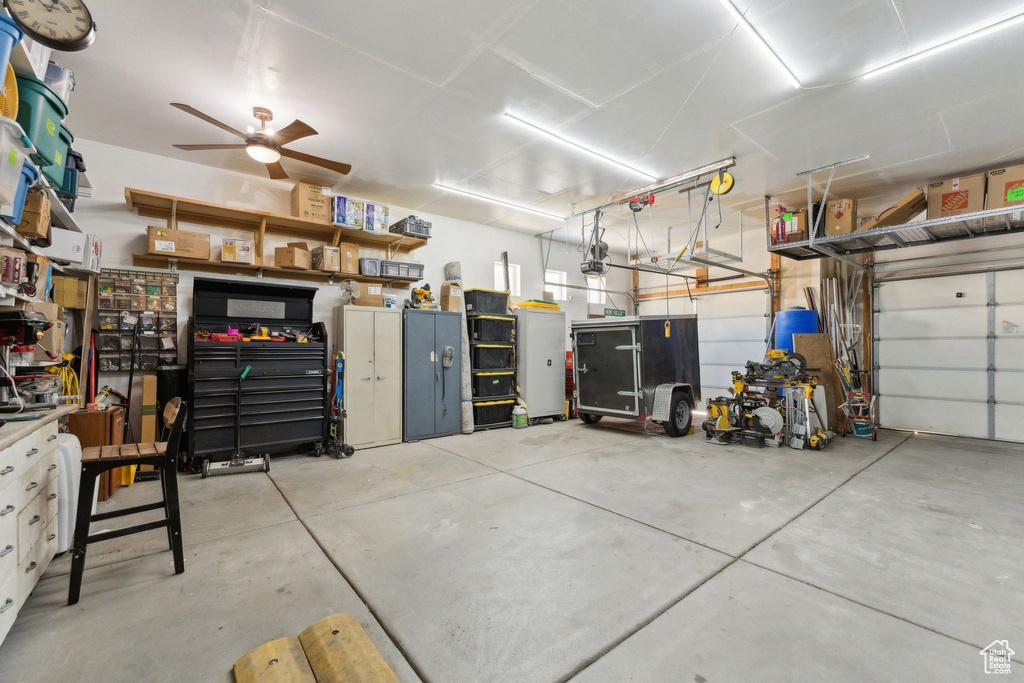 Garage featuring a ceiling fan and a garage door opener