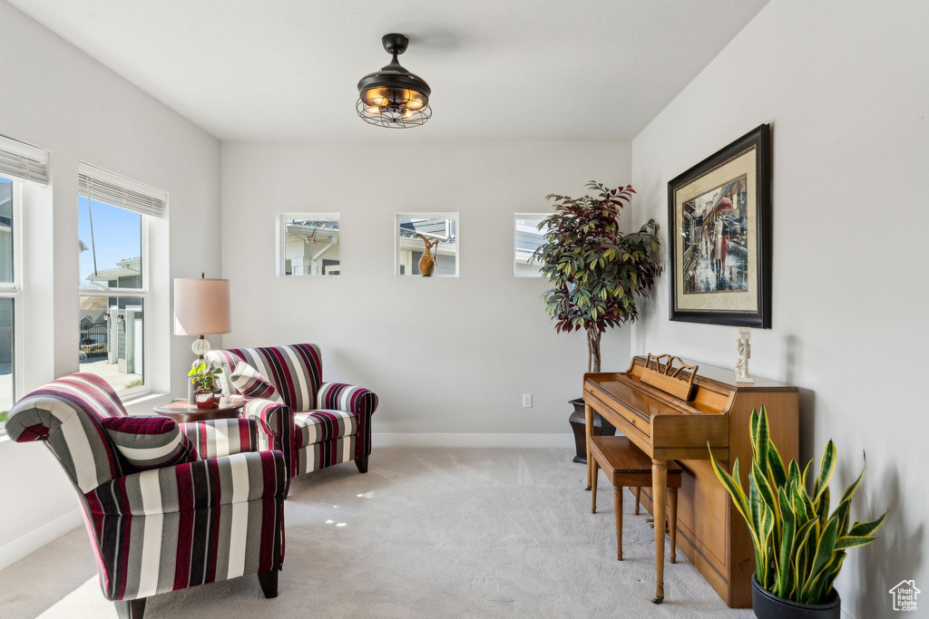 Living area featuring baseboards and carpet