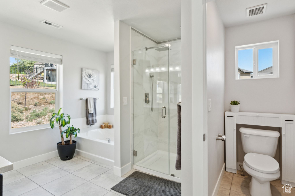 Full bath featuring visible vents, tile patterned flooring, toilet, a bath, and a marble finish shower
