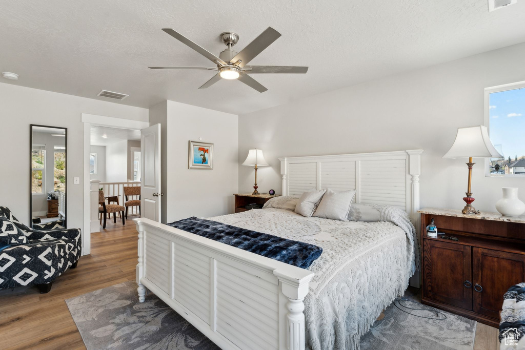 Bedroom with ceiling fan, visible vents, and light wood-type flooring