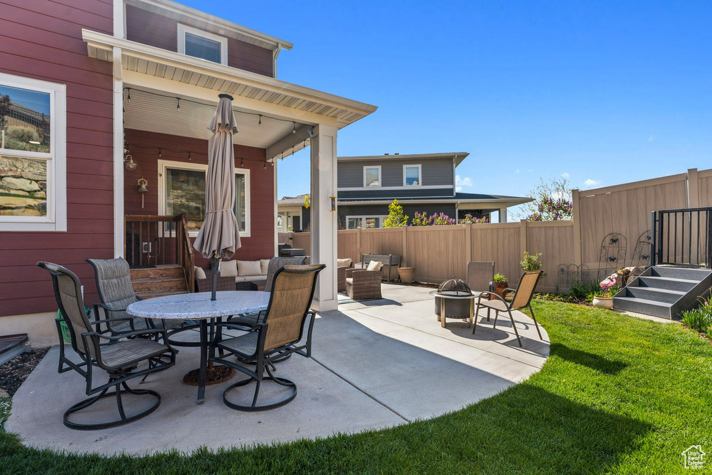 View of patio / terrace featuring an outdoor living space with a fire pit and fence