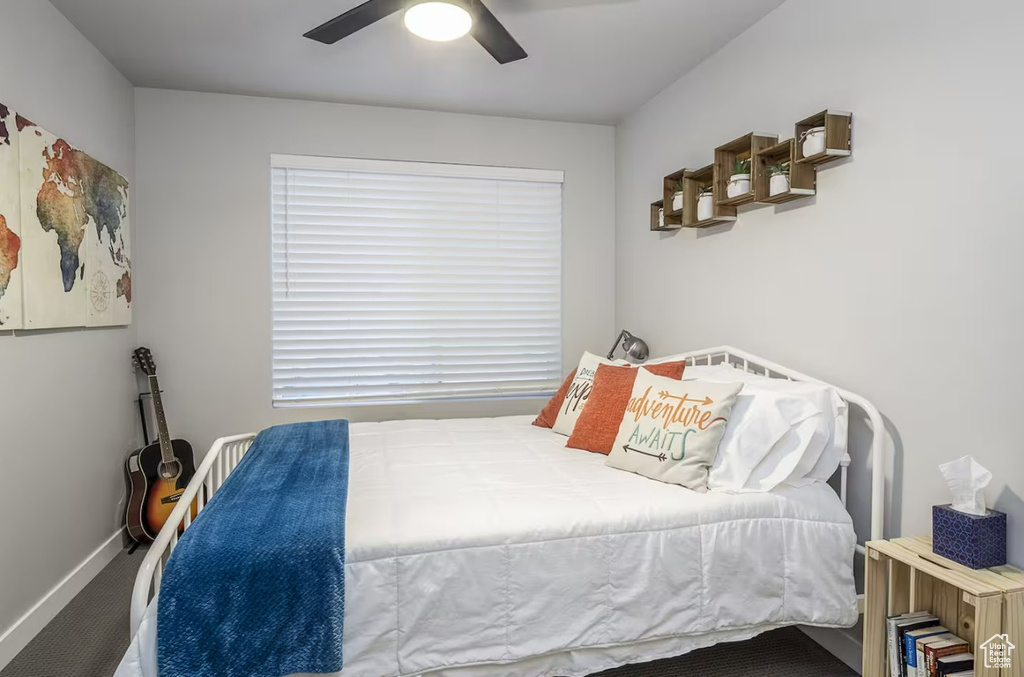 Bedroom featuring baseboards, carpet flooring, and ceiling fan