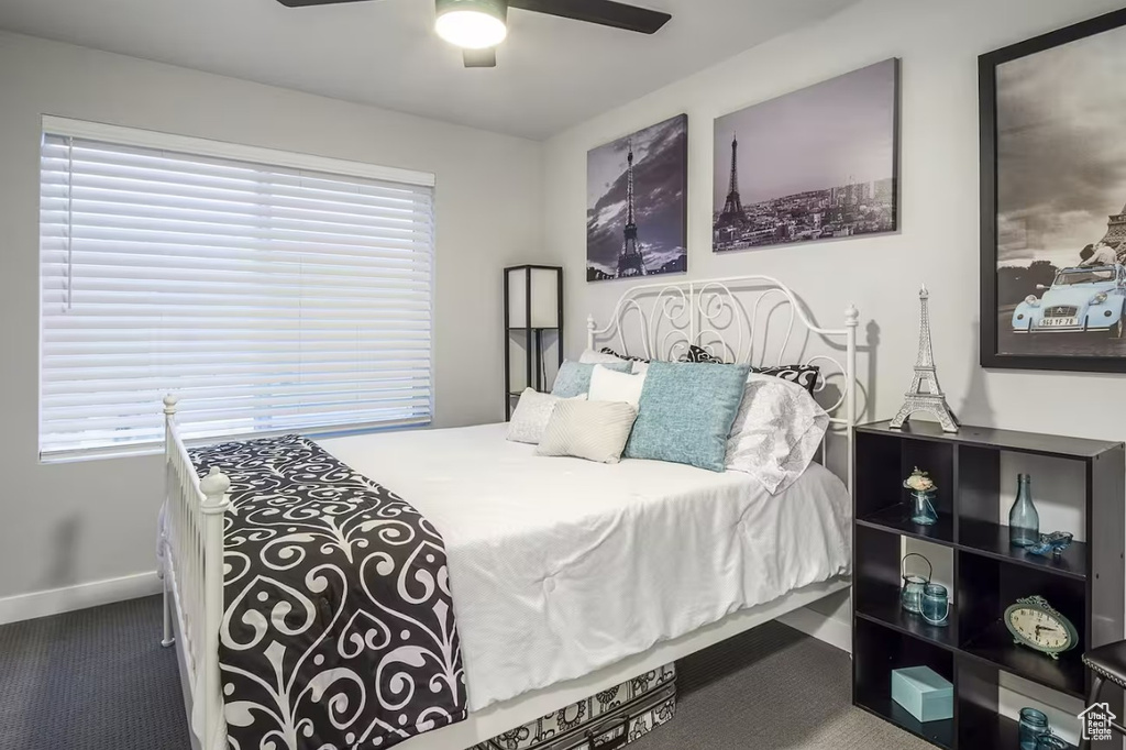Bedroom featuring baseboards, ceiling fan, and carpet