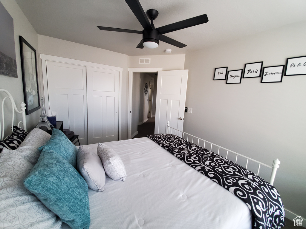 Bedroom with a ceiling fan and a closet