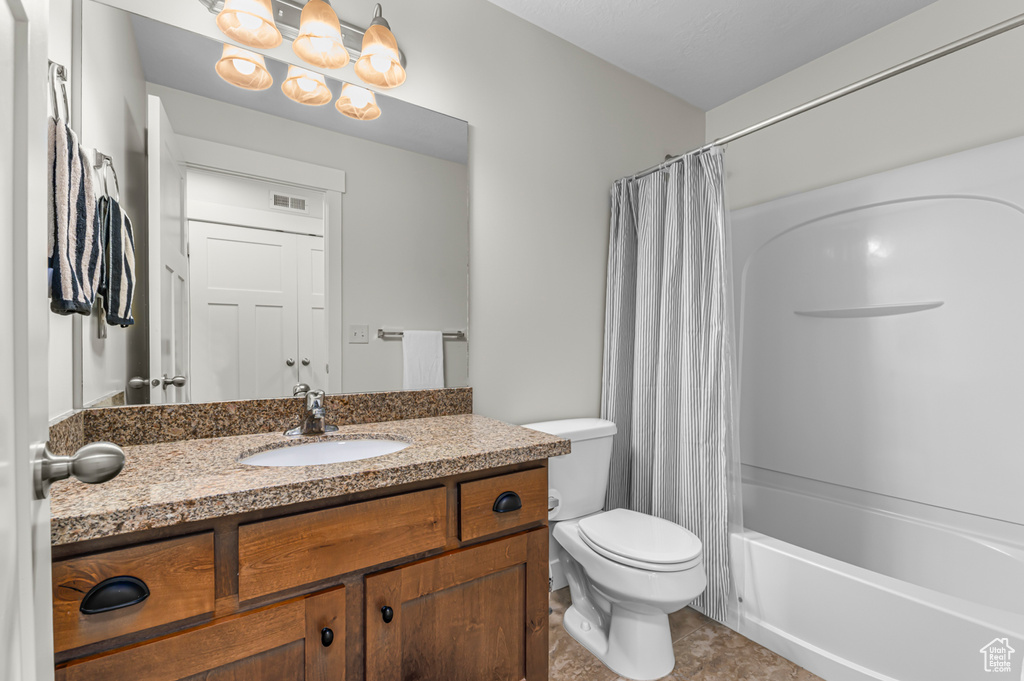 Full bath featuring vanity, tile patterned flooring, visible vents, shower / bath combination with curtain, and toilet