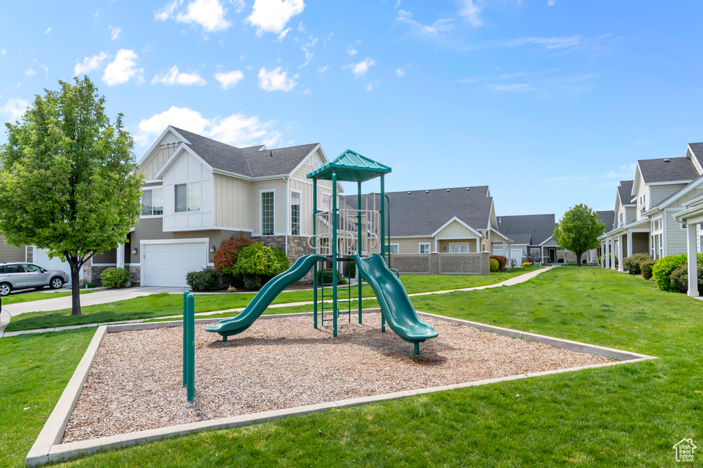 Communal playground with a yard and a residential view