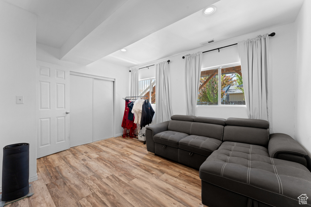 Living room with recessed lighting, visible vents, and light wood-style floors