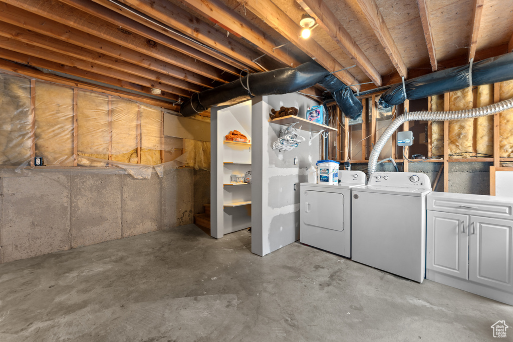 Unfinished basement with washing machine and dryer