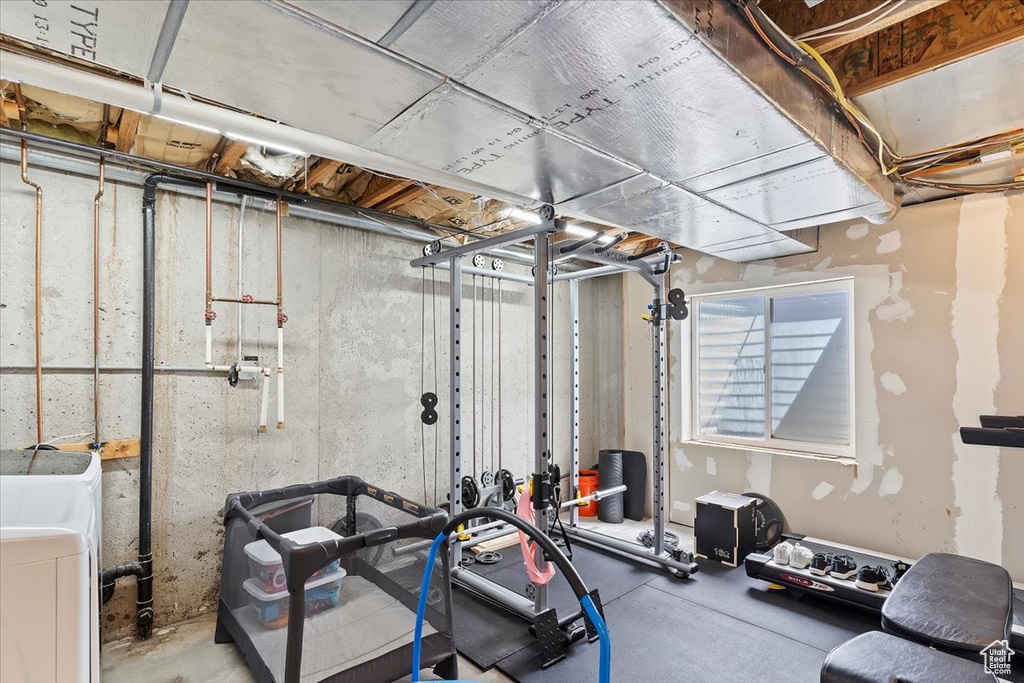Exercise room featuring washer / dryer