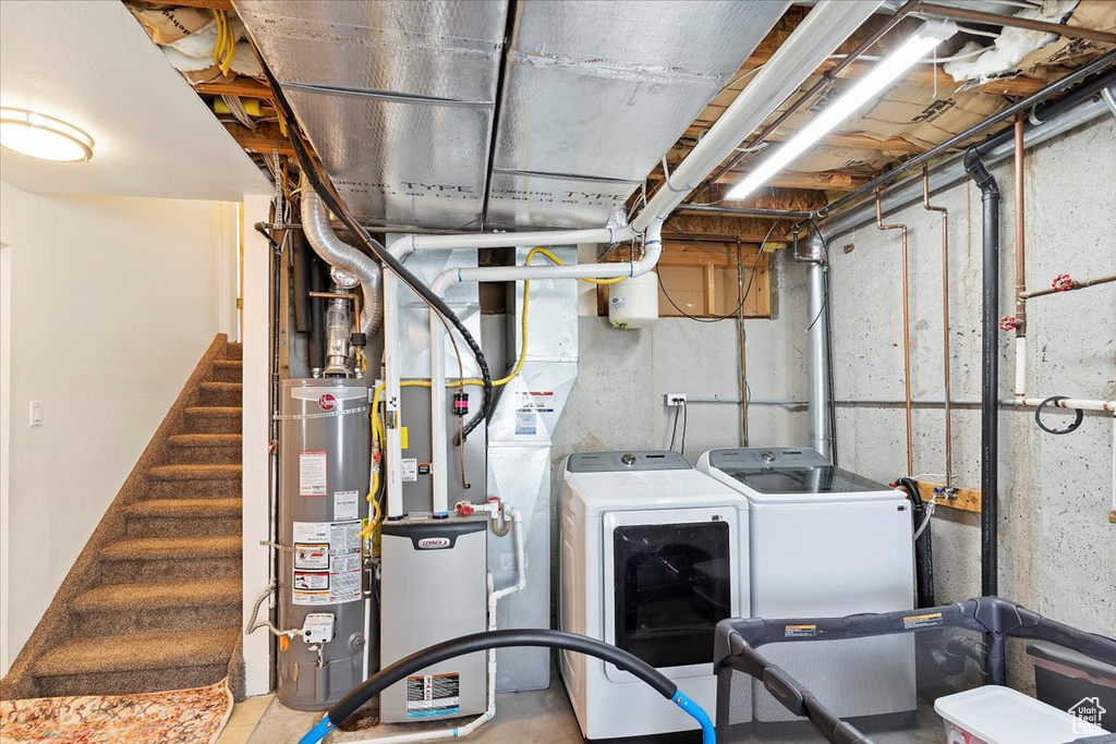 Utilities featuring washer and clothes dryer and gas water heater
