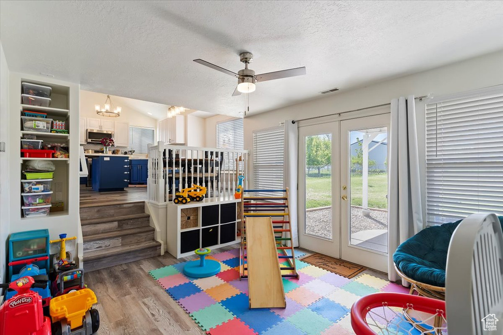 Game room with french doors, a textured ceiling, wood finished floors, and visible vents