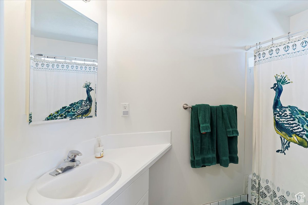Full bathroom with vanity and curtained shower