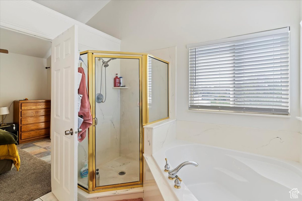 Bathroom with a marble finish shower, ensuite bath, and a bath