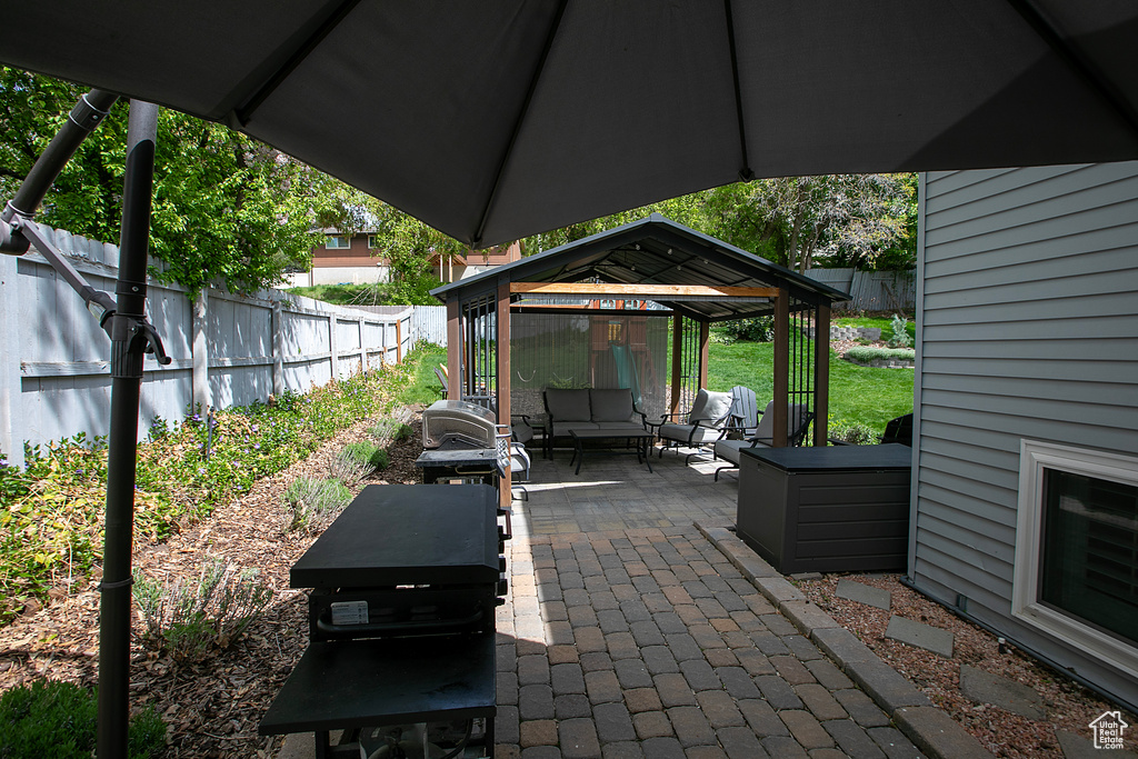View of patio / terrace with a gazebo, a fenced backyard, and an outdoor hangout area