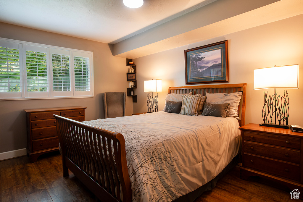 Bedroom with baseboards and wood finished floors