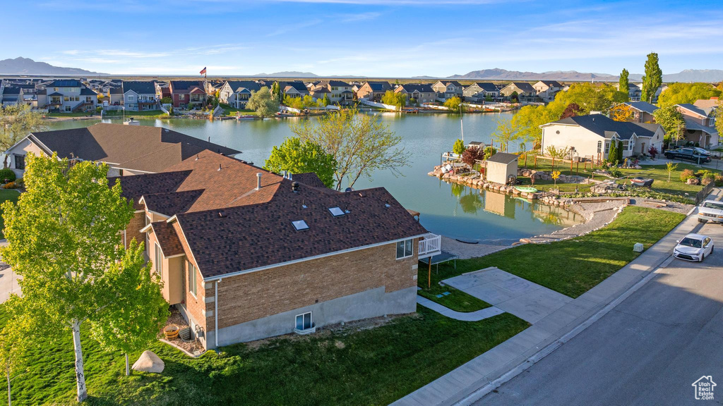 Birds eye view of property with a water and mountain view and a residential view