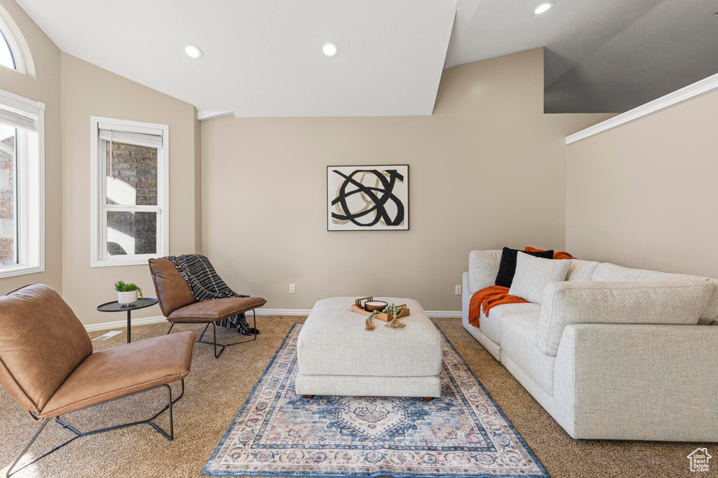 Carpeted living area with recessed lighting and baseboards