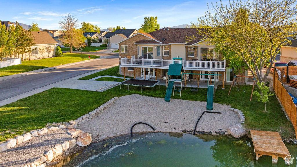 View of home\\\'s community with a lawn, a playground, and a residential view