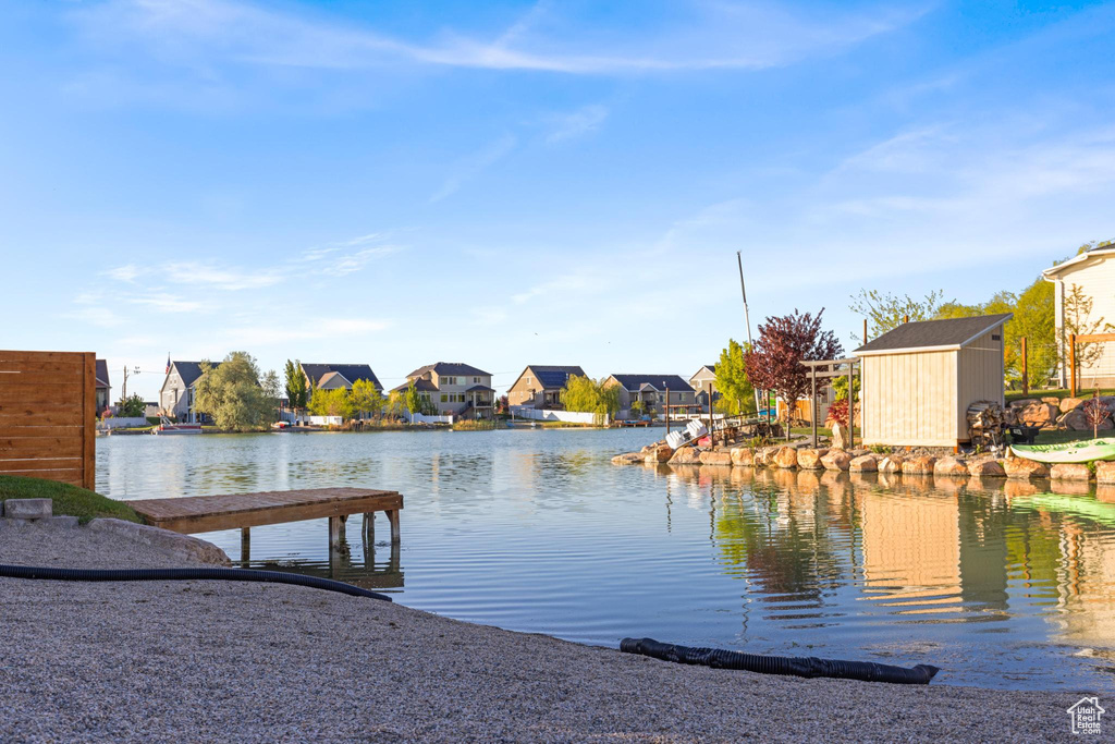 View of dock with a water view and a residential view