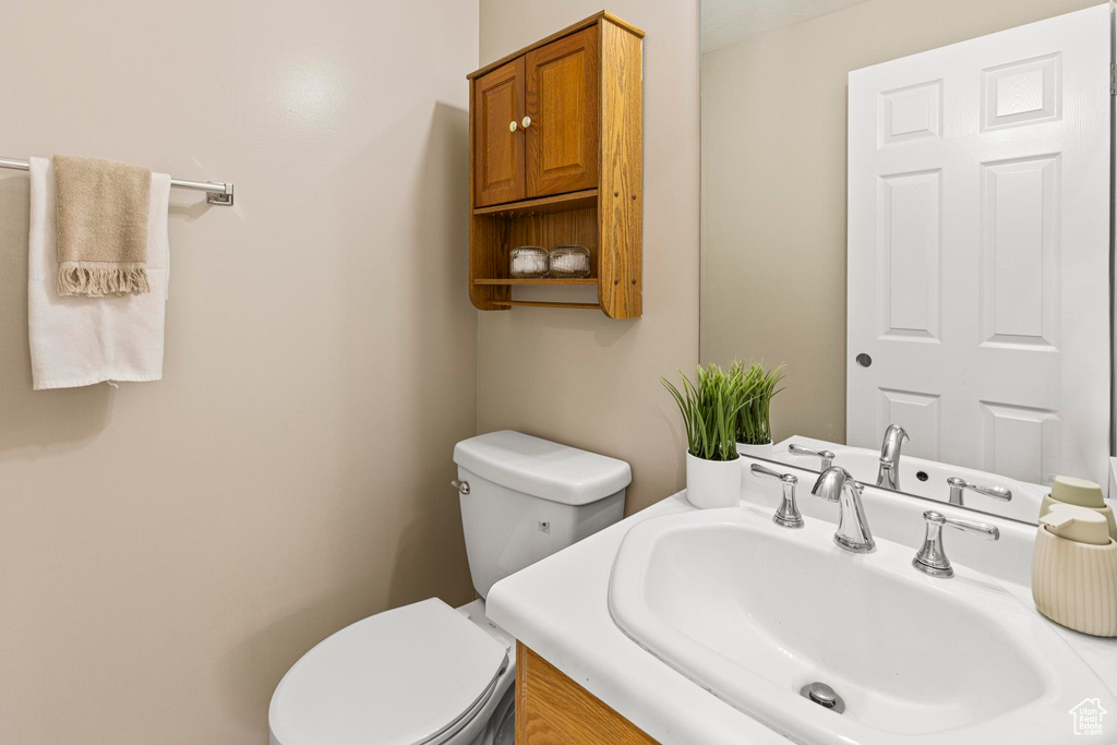 Half bathroom with toilet and vanity