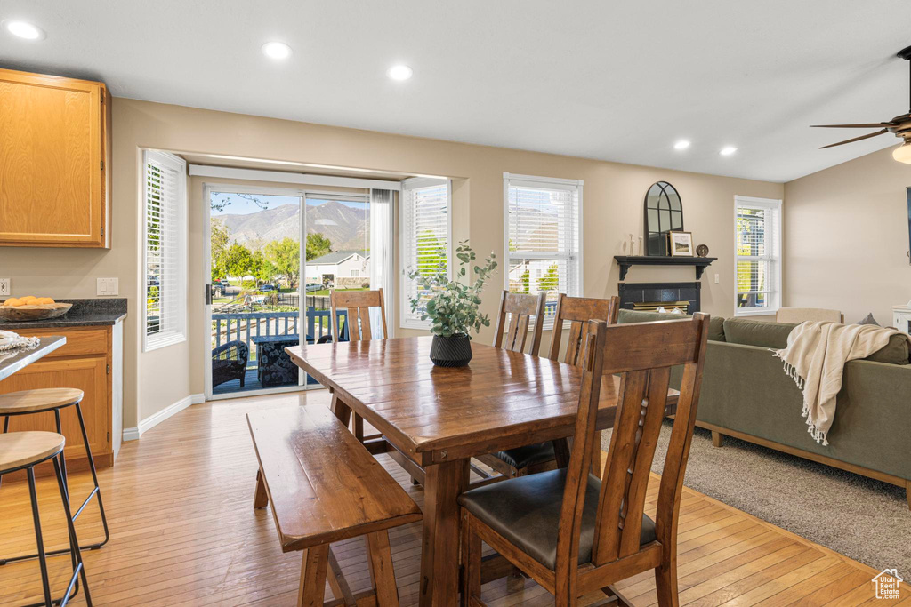 Dining room featuring a glass covered fireplace, recessed lighting, ceiling fan, and light wood-type flooring