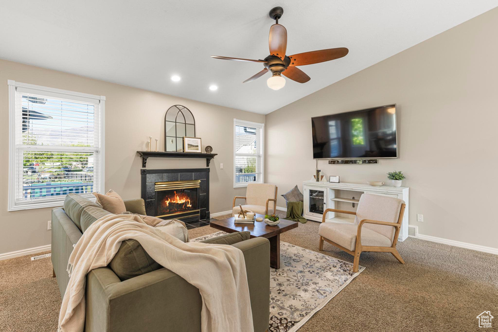 Carpeted living room with a ceiling fan, baseboards, recessed lighting, lofted ceiling, and a tile fireplace