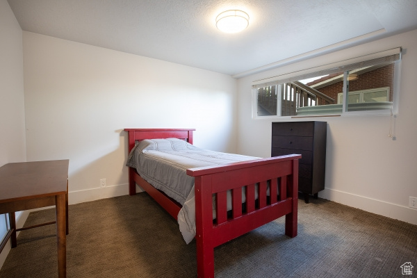 Carpeted bedroom featuring baseboards