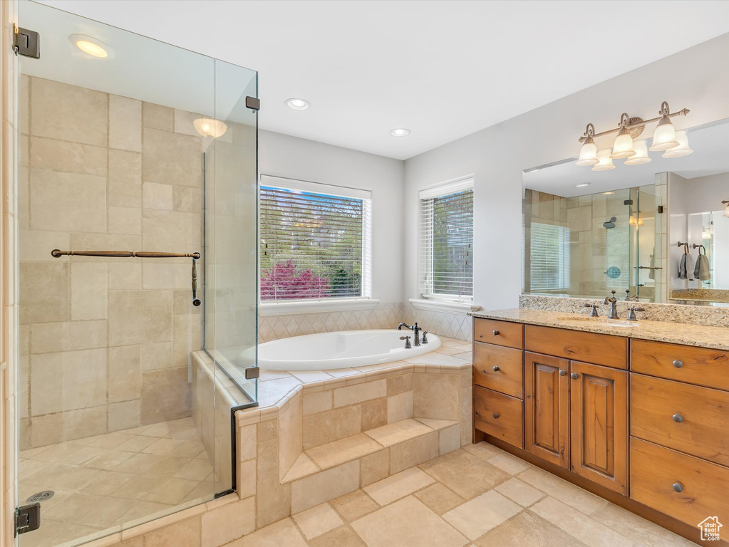 Bathroom featuring vanity, a shower stall, recessed lighting, and a bath