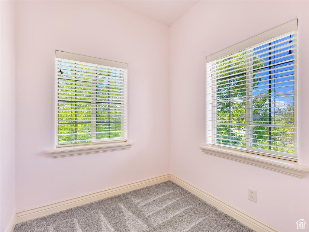 Spare room featuring carpet floors and baseboards