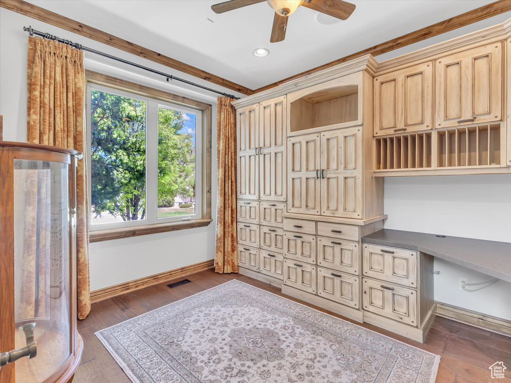 Unfurnished office featuring built in study area, a ceiling fan, baseboards, recessed lighting, and wood finished floors