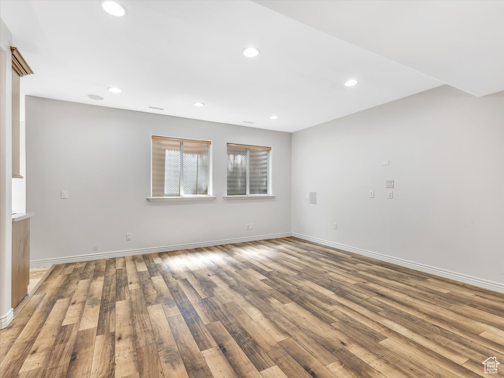 Spare room with recessed lighting, baseboards, and wood finished floors
