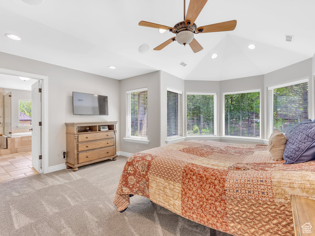 Bedroom with light carpet, recessed lighting, baseboards, vaulted ceiling, and connected bathroom