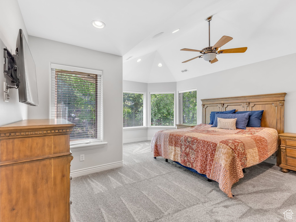 Carpeted bedroom featuring multiple windows, lofted ceiling, baseboards, recessed lighting, and ceiling fan