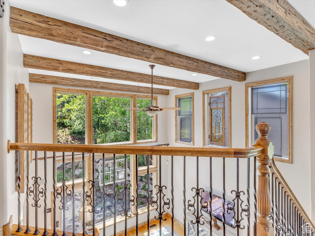 Corridor with beamed ceiling, recessed lighting, and wood finished floors