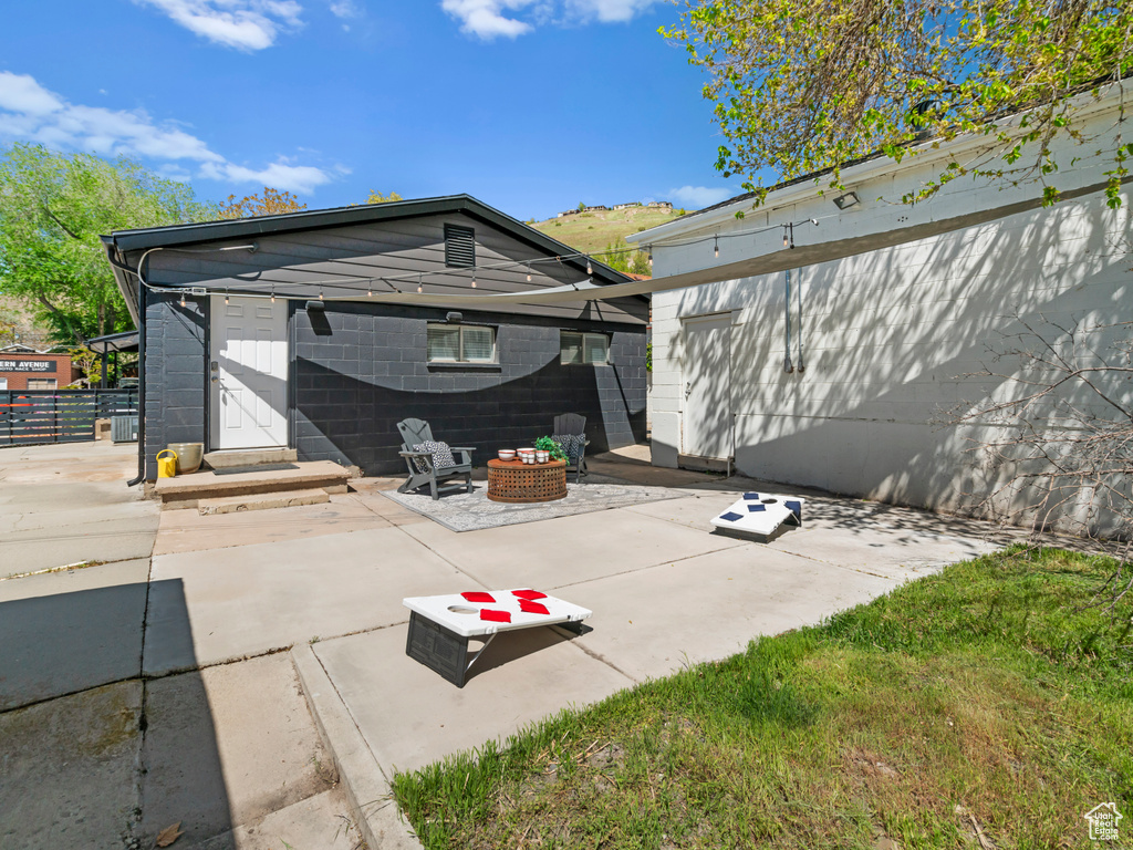 View of patio featuring fence