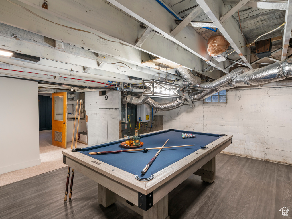 Recreation room with billiards, wood finished floors, and water heater